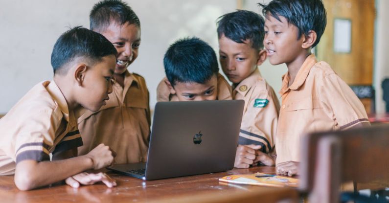 Group Study - Boy Using Silver Macbook Indoors