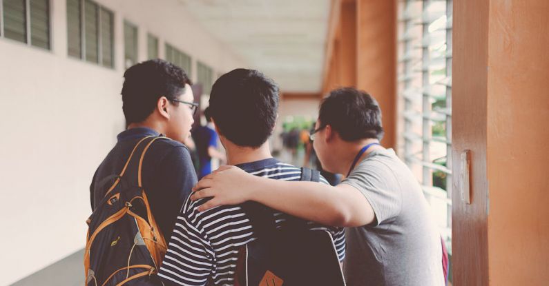 High School - Three Men Standing Near Window