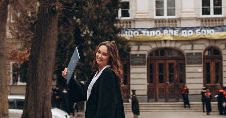 Academic Integrity - A woman in a black coat and white dress is standing outside a building