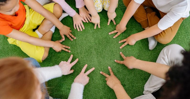 Study Groups - Group of Children Playing on Green Grass