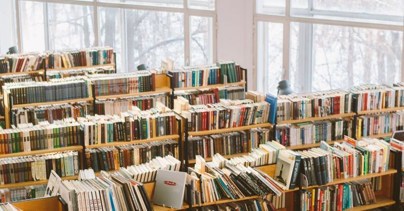 College Textbooks - Books on Brown Wooden Shelf