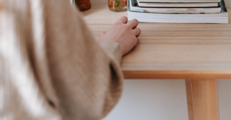 Textbook Quality - Unrecognizable freelancer working on laptop at home table