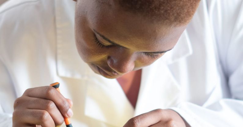 Condition - Focused technician in lab coat checking current of electricity with voltmeter while examining condition of graphics card in workshop