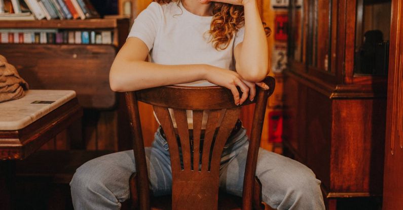 Library Closure - Woman Sitting in Wooden Chair